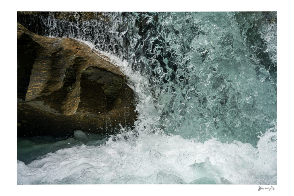Waterfall Wall Art, Frozen Water Print, Switzerland Nature Photography, Abstract Water Droplets, Minimalist Fine Art Photo Print Switzerland fine art photography print of a waterfall captured with an ultra-short exposure time by Stan Weyler. High-speed detail study showing frozen water droplets and splashing spray cascading over a dark cliff edge. Minimalist, abstract nature wall art for modern living rooms, offices, and gallery displays, printed on museum-quality matte paper.