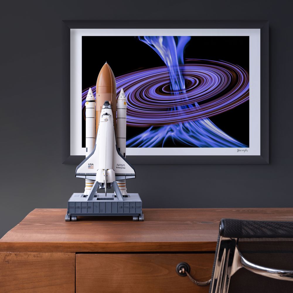 Abstract cosmic fine art print titled Flux Malva by Stan Weyler from the Cosmic Visions collection. Digital astrophotography artwork featuring a bright electric blue plasma beam shooting vertically through a swirling purple and black galaxy accretion disk. Modern Sci-Fi wall decor for game rooms, offices, and modern spaces, printed on museum-quality archival matte paper.